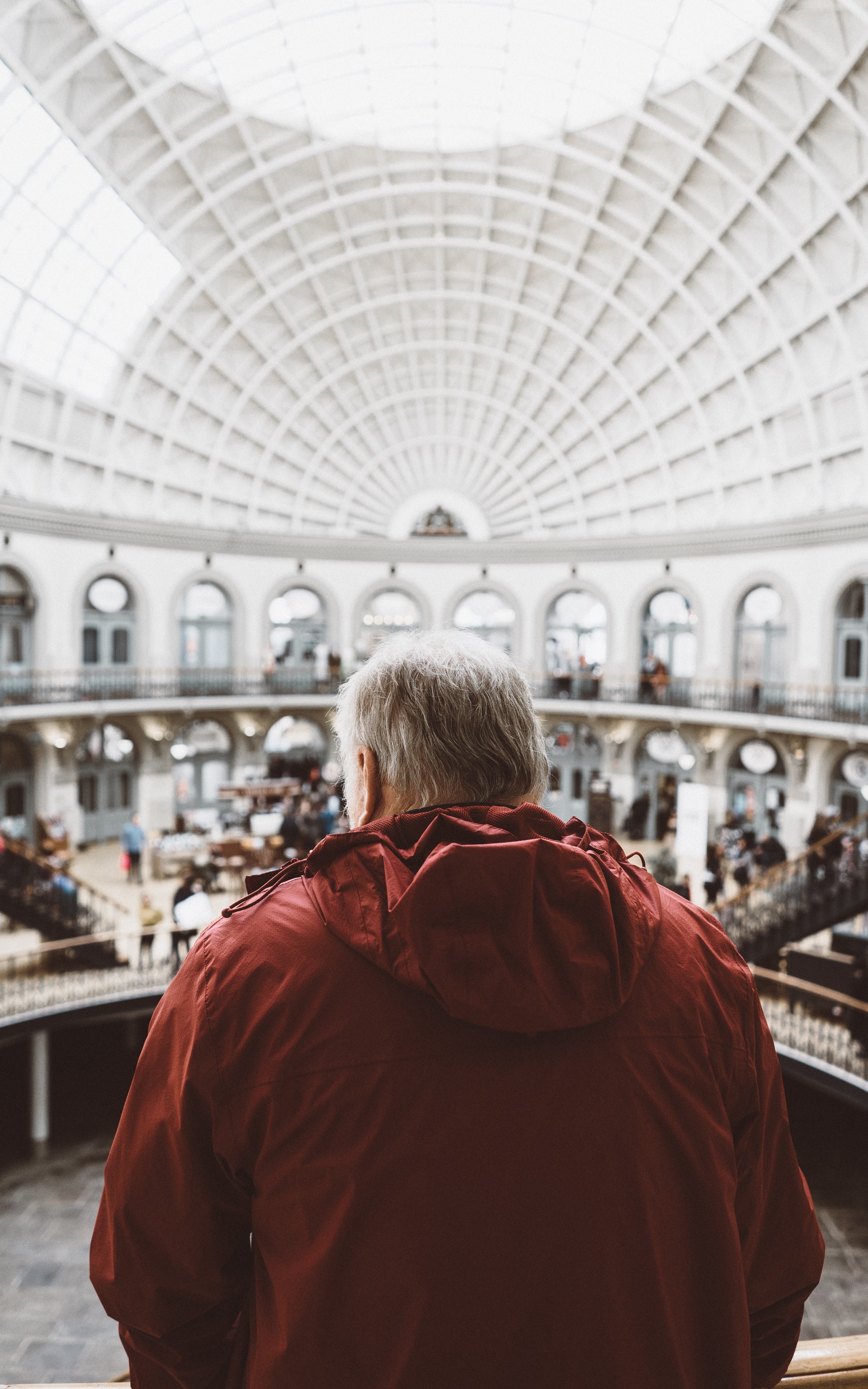 A man in a red jacket inside the museum